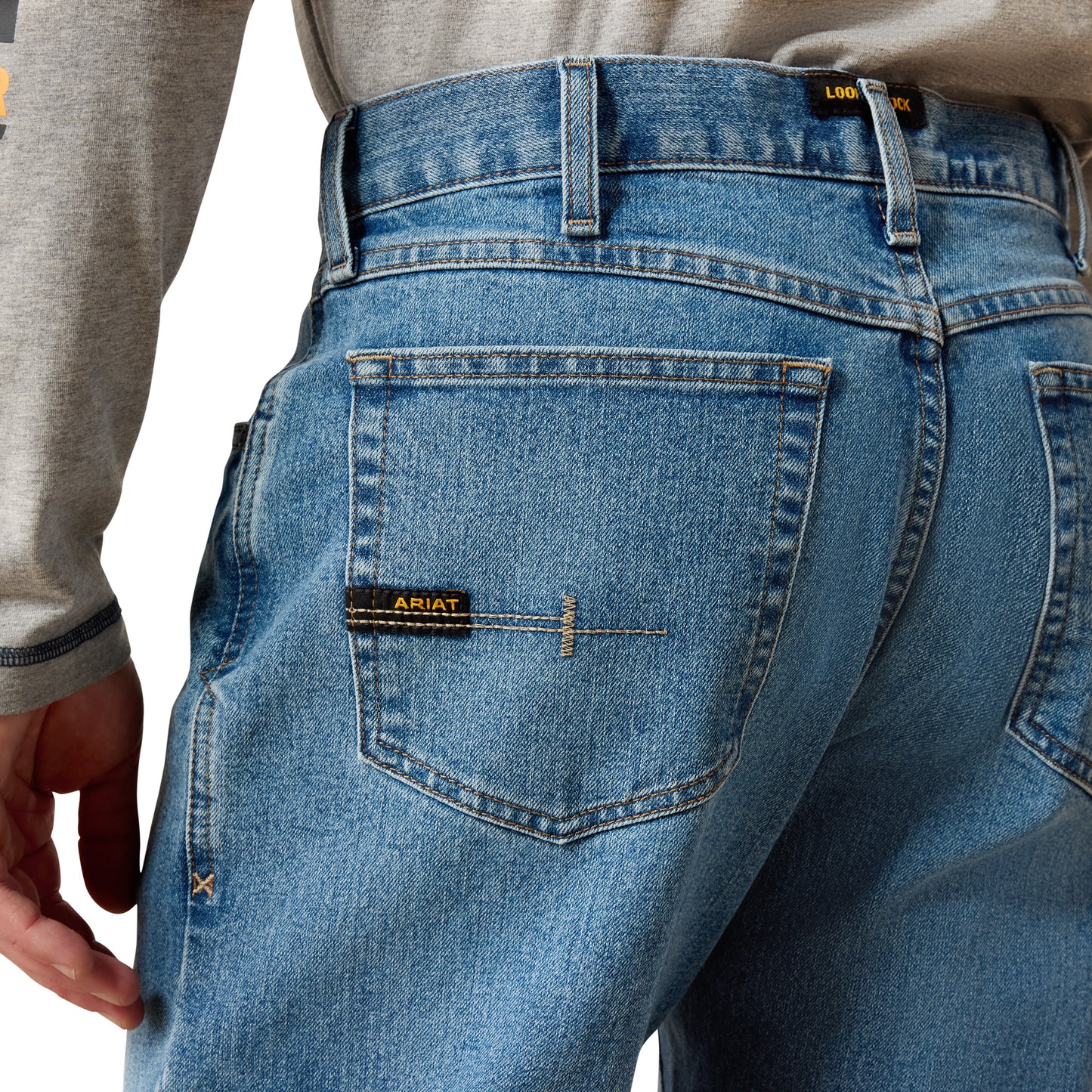 man wearing denim Ariat jeans on a white background