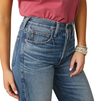 a woman wearing high rise Ariat jeans