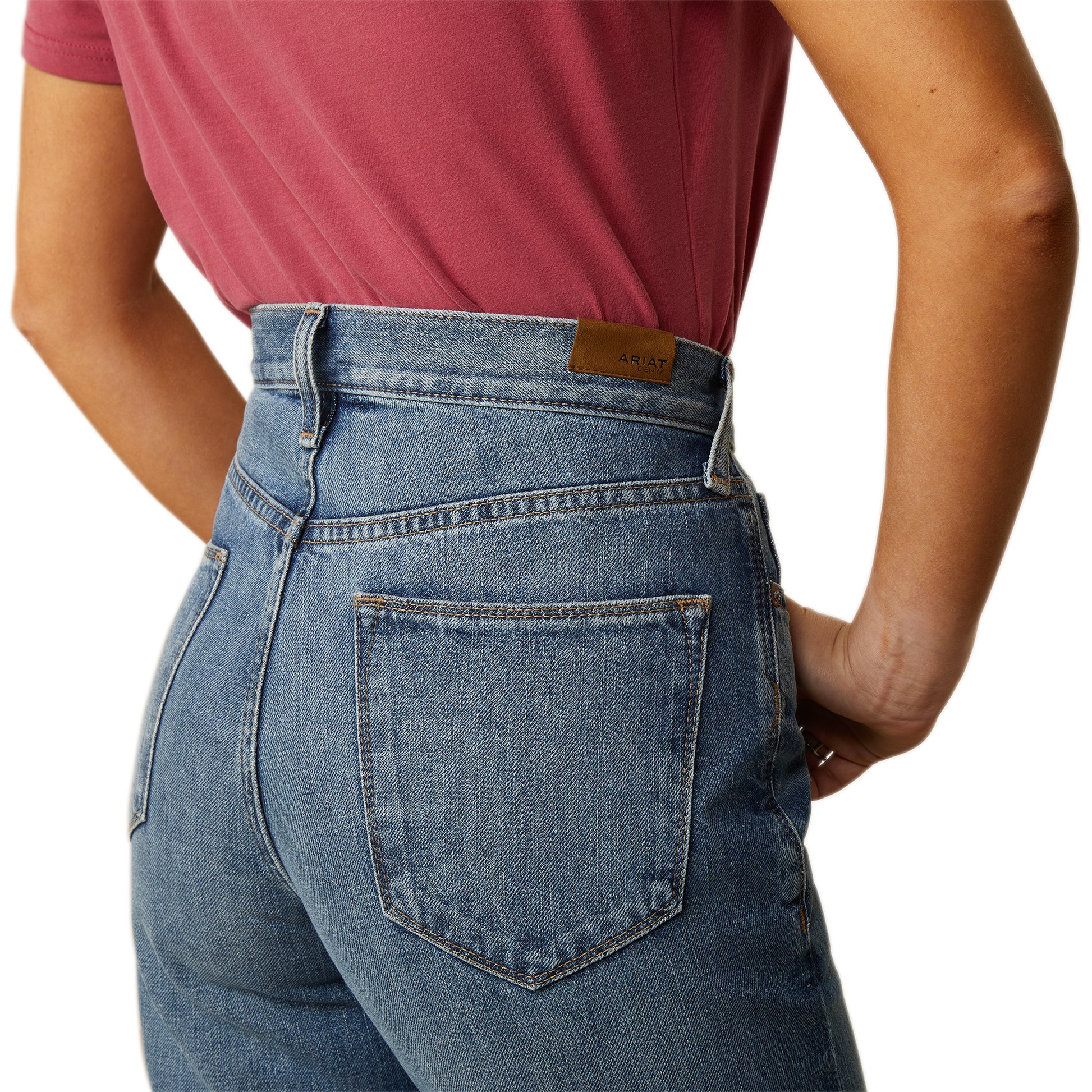 a woman wearing high rise jeans