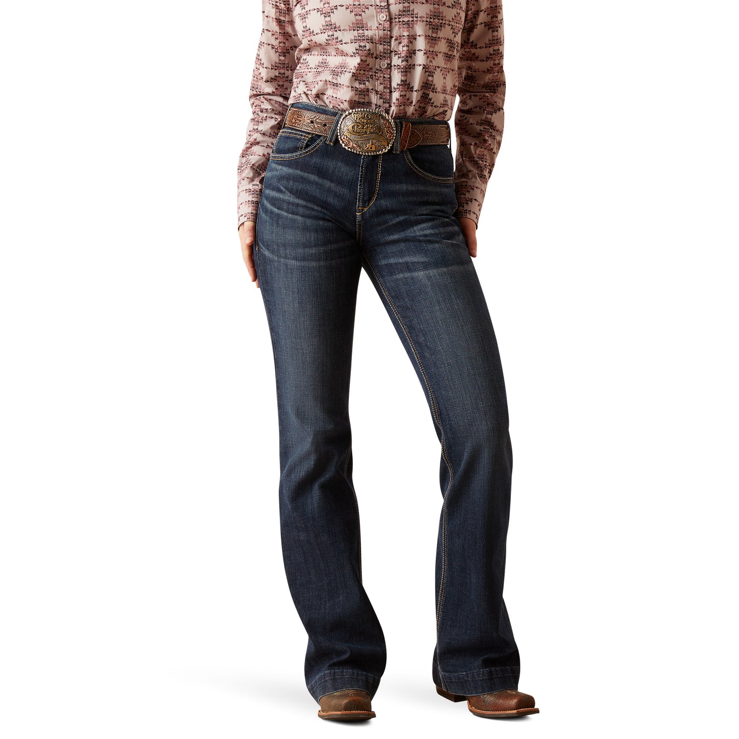 woman wearing high rise blue jeans with a brown belt and shirt on a white background