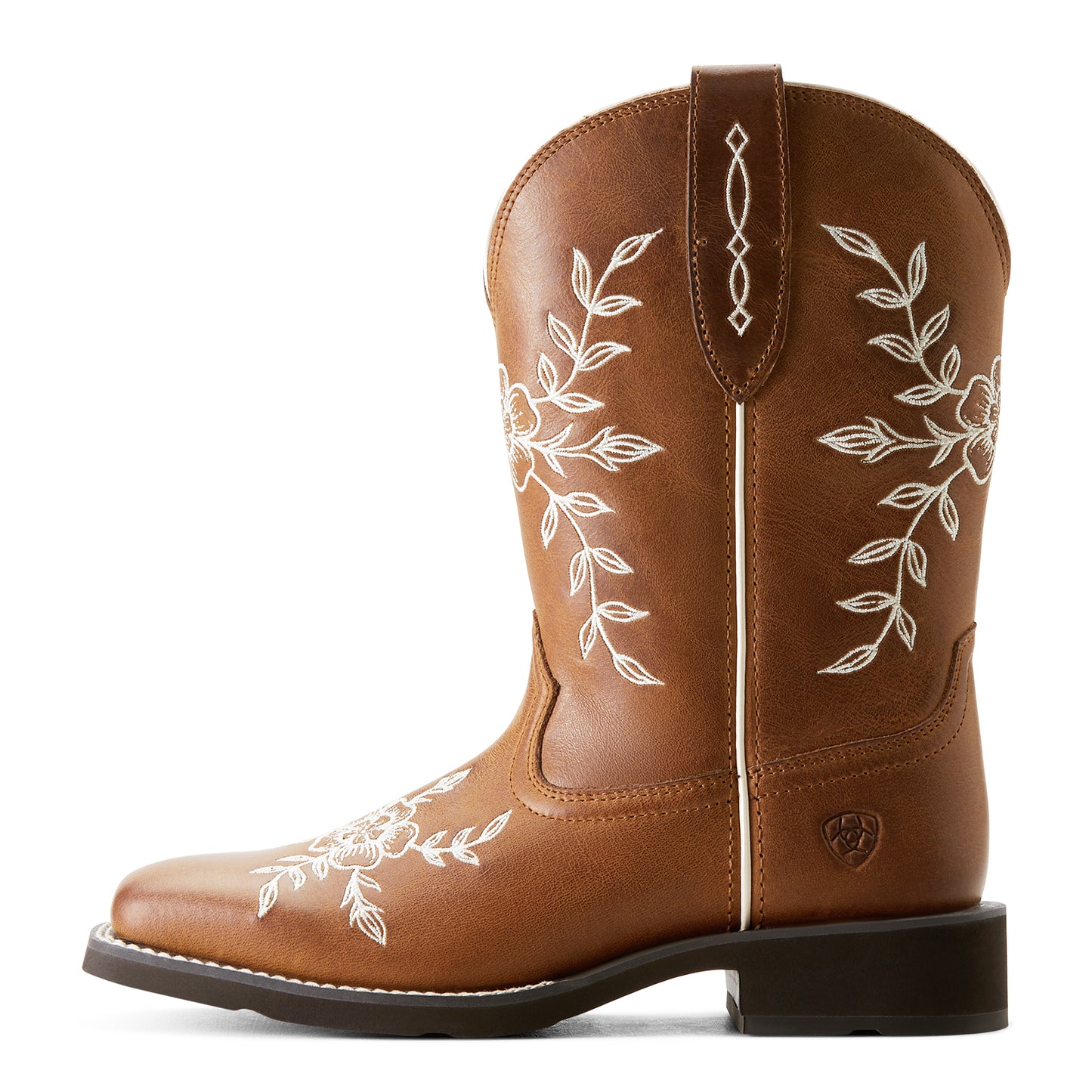 a side view of a brown cowboy boot with white floral embroidery with an ariat logo
