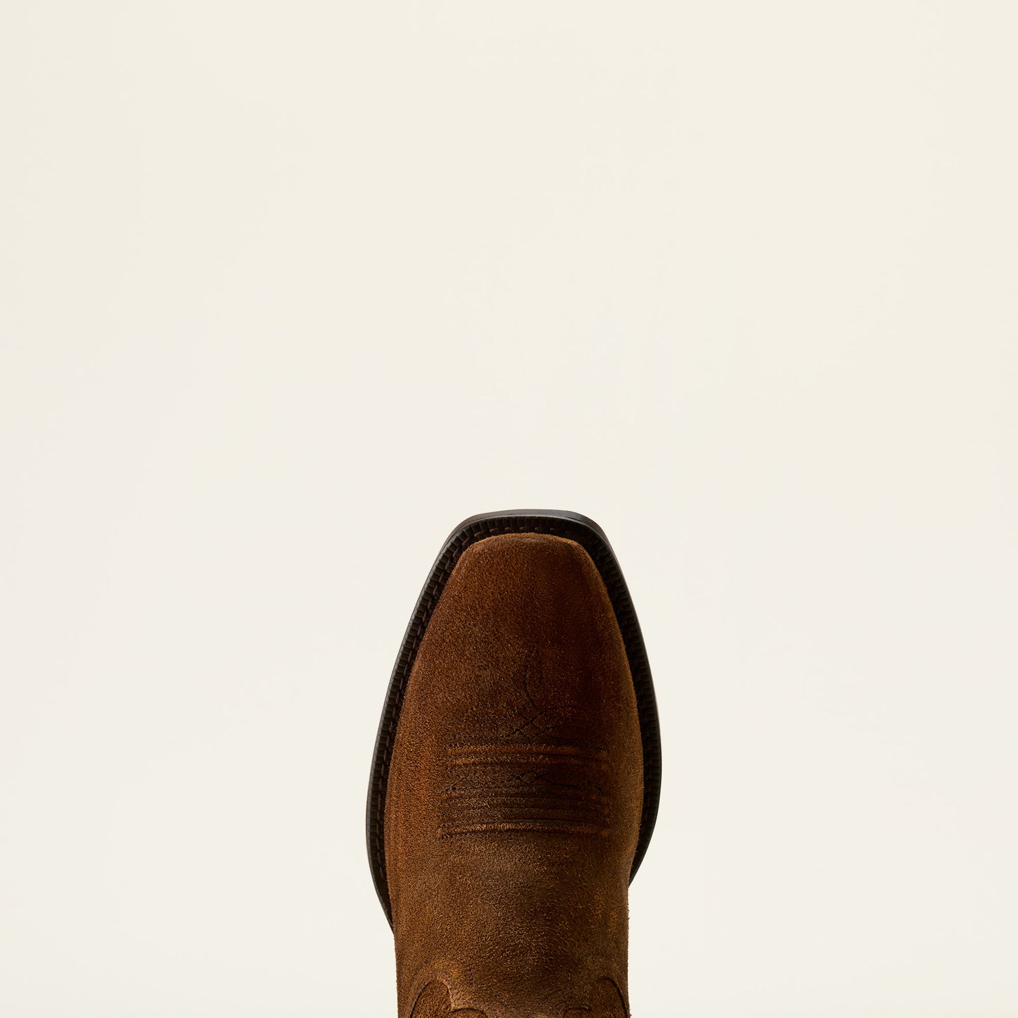 a close up of a suede narrow square toe cowboy boot