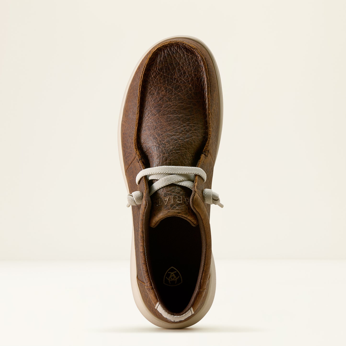 the top of a men's brown elephant print hilo shoe by ariat on an off white background