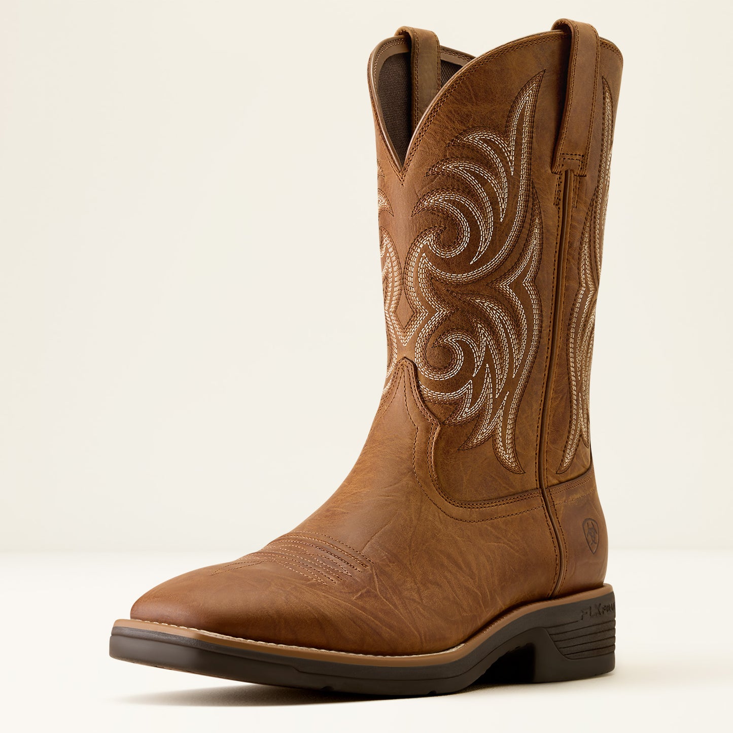 a tan brown wide squre toe cowboy boot by ariat on a off white background