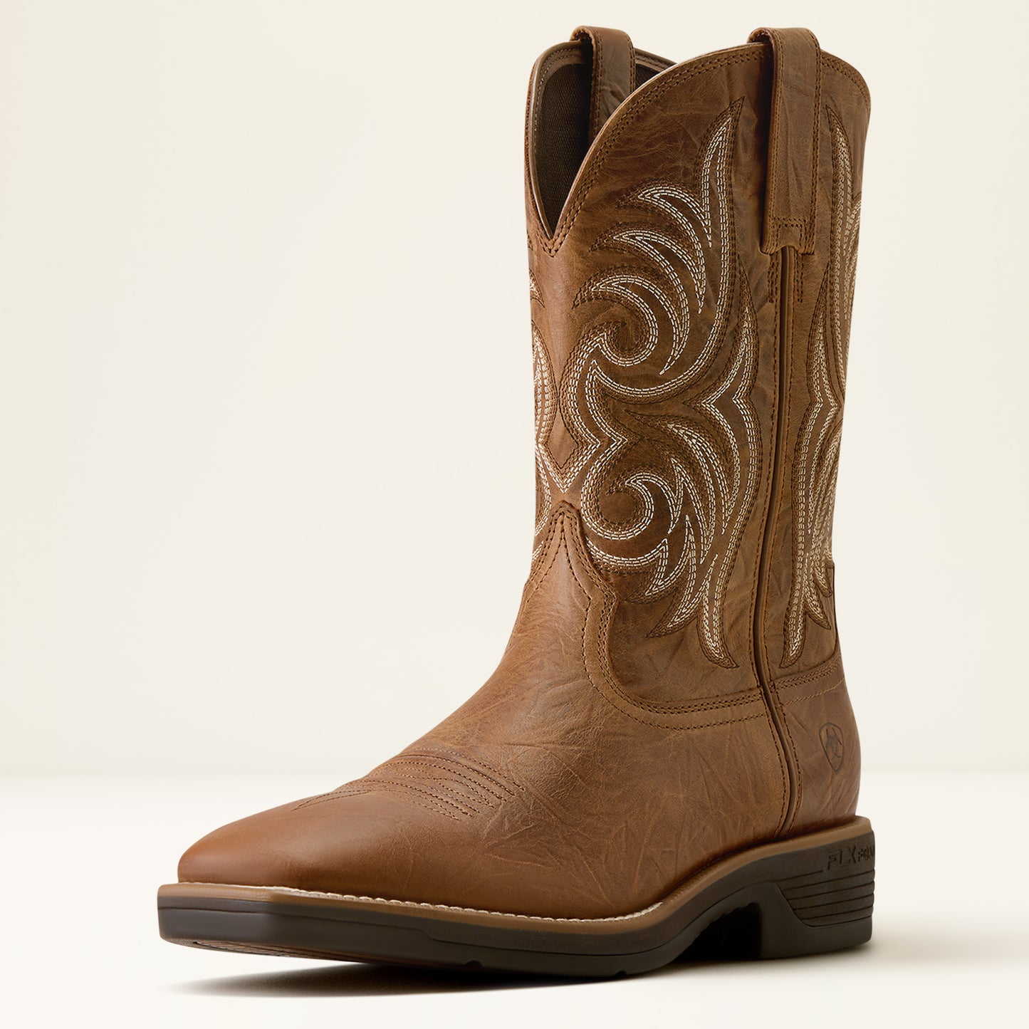 A single brown leather cowboy boot with decorative western embroidery on the shaft, shown from a side profile against a light cream background.