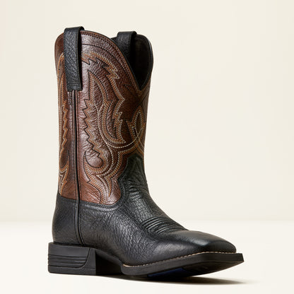 a brown and black wide square toe ariat boot on a cream background