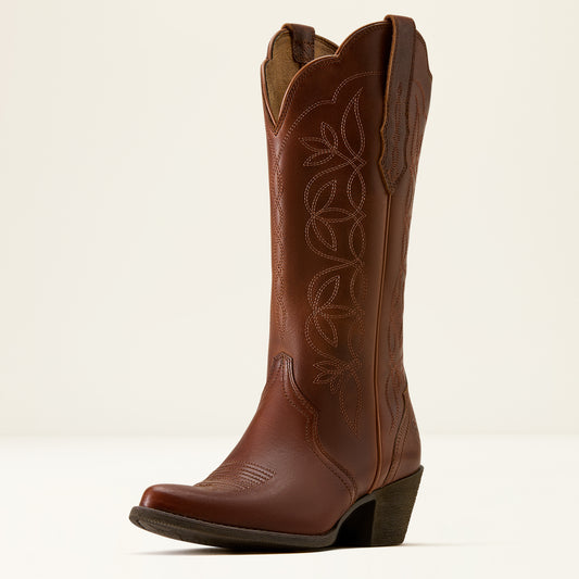 A single brown leather cowboy boot with decorative floral stitching on the shaft, a pointed toe, and a low block heel, photographed against a clean off-white background.