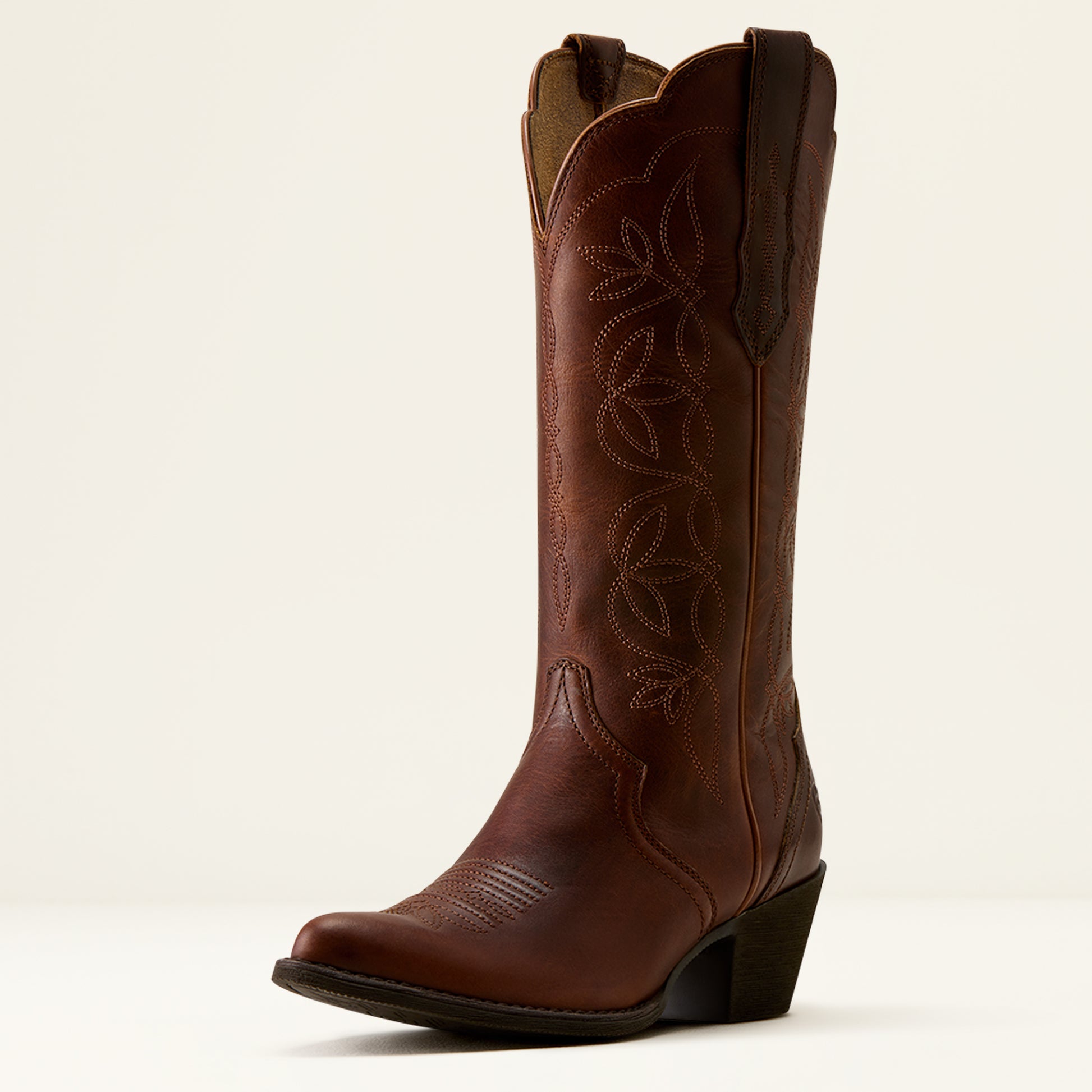 A single brown leather cowboy boot with decorative western-style stitching and a low block heel, photographed against a clean off-white background.