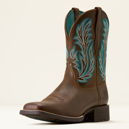 A brown leather cowboy boot with turquoise and white embroidered patterns on the shaft, shown from a three-quarter angle against a light beige background.
