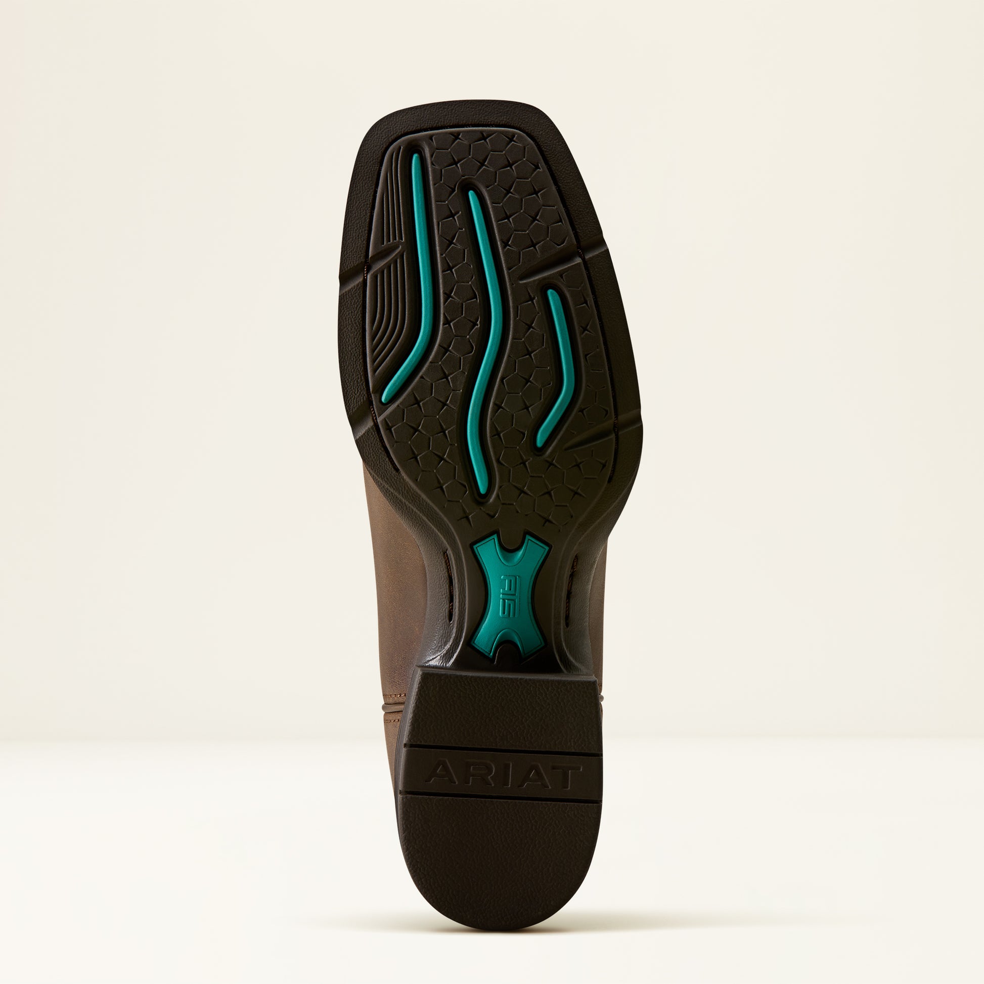 The outsole of a brown Ariat boot, showing a black tread pattern with bright teal accents and the Ariat brand name embossed on the heel.