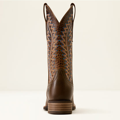 A single brown leather cowboy boot shown from the back, featuring a textured alligator-pattern shaft with geometric embroidered details in orange, blue, and white.