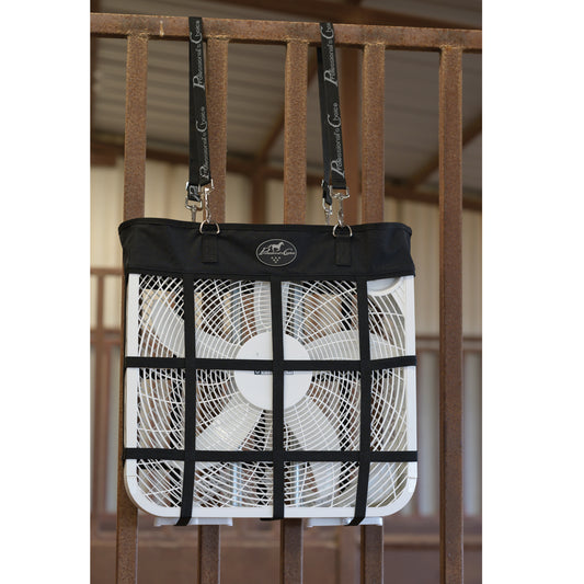 A black and white cooling fan guard net with a white fan inside, hanging from black branded straps on a brown railing.
