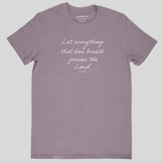 A dusty purple crewneck t-shirt from Grace & Truth with white cursive text reading 'Let everything that has breath praise the Lord' and 'PSALM 150:6' printed on the chest, displayed flat against a light gray background