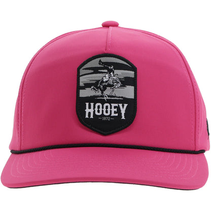 a pink hooey cap with black accents and a patch with a bucking horse that says 'hooey'