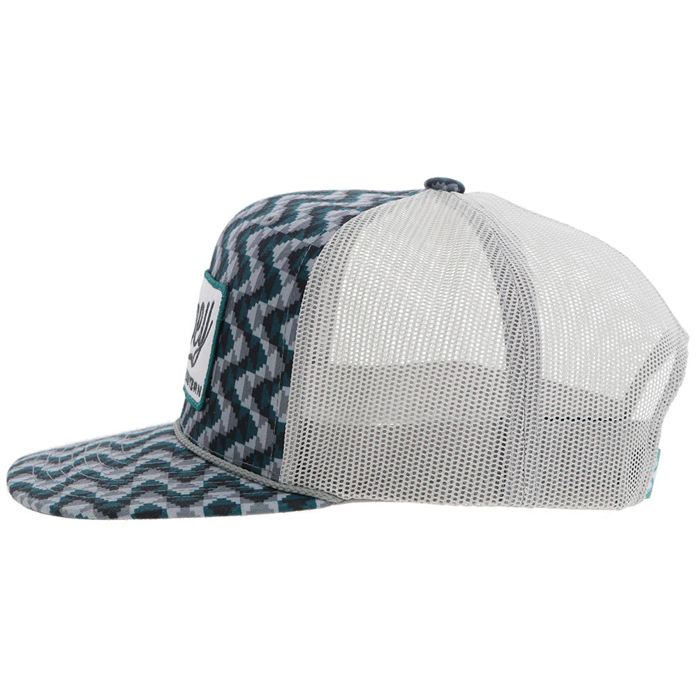 a chevron printed teal and grey trucker cap with a patch that says 'hooey western' on a white background