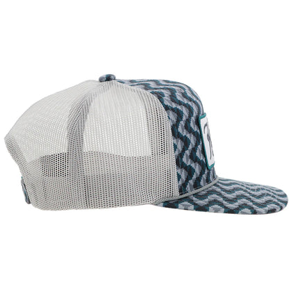 a chevron printed teal and grey trucker cap with a patch that says 'hooey western' on a white background