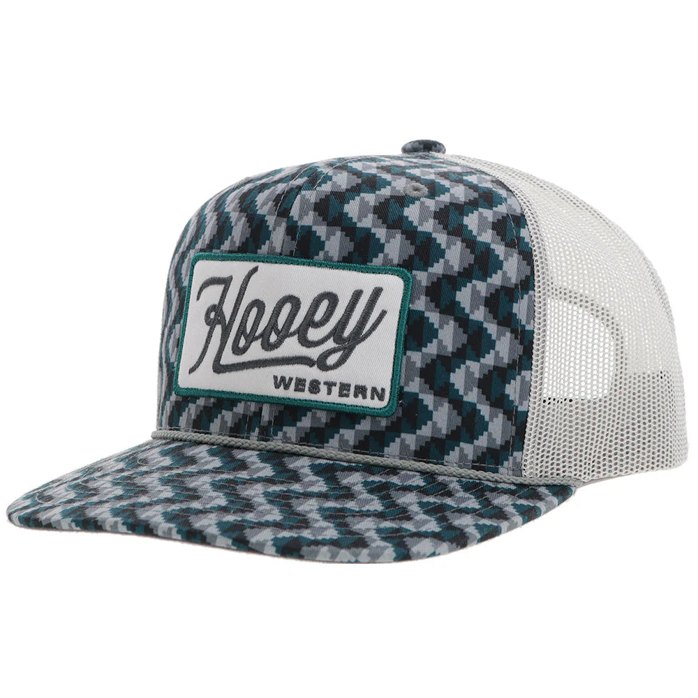 a chevron printed teal and grey trucker cap with a patch that says 'hooey western' on a white background