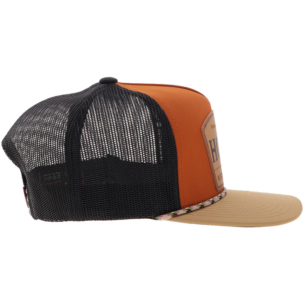 Black, orange, and beige trucker hat on a white background