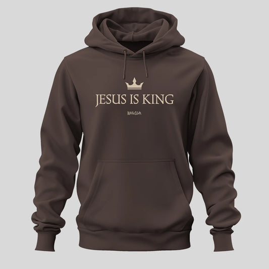 A dark brown pullover hoodie from Kerusso with a front kangaroo pocket and drawstring hood, featuring a gold crown graphic and the text 'JESUS IS KING' set against a solid light gray background.