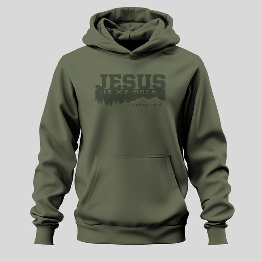 An olive green pullover hoodie from Kerusso with a dark green graphic on the chest that reads 'JESUS IS MY ROCK' and 'PSALM 18:2' below it, displayed on a solid gray background.