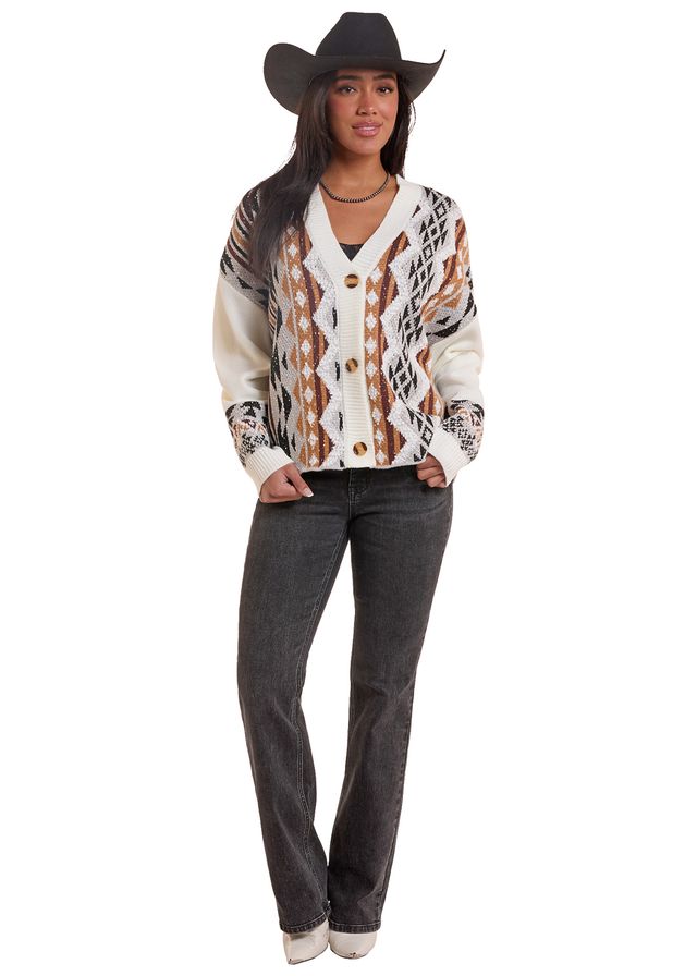 Woman wearing a natural colored Rock&Roll Denim cardigan, blue jeans and a black cowboy hat on a white background