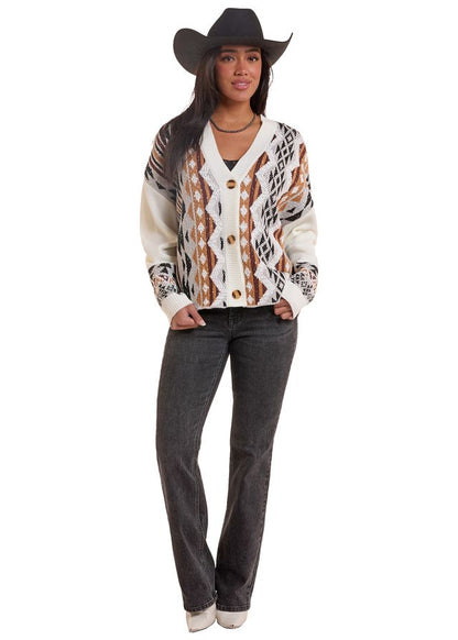 Woman wearing a natural colored Rock&Roll Denim cardigan, blue jeans and a black cowboy hat on a white background