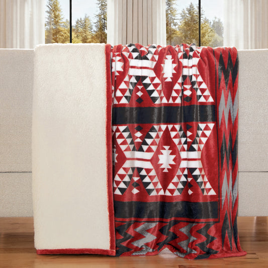 a red southwest print sherpa blanket draped over a sofa in a living room setting