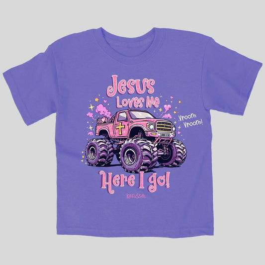 A purple short-sleeve t-shirt from Kerusso with a graphic of a pink monster truck and the text 'Jesus Loves Me Here I go!' on a light gray background.