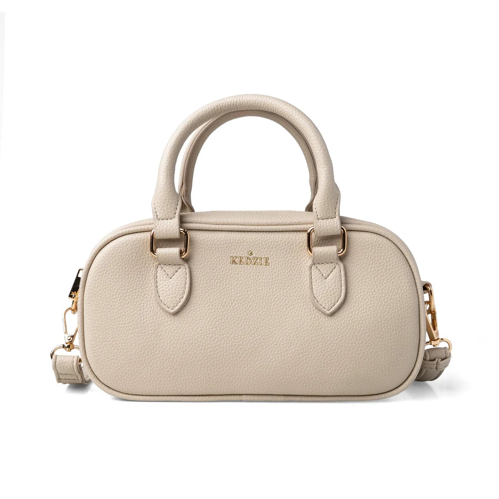 Cream crossbody bag from Kedzie with removable strap and tote handles on a white background