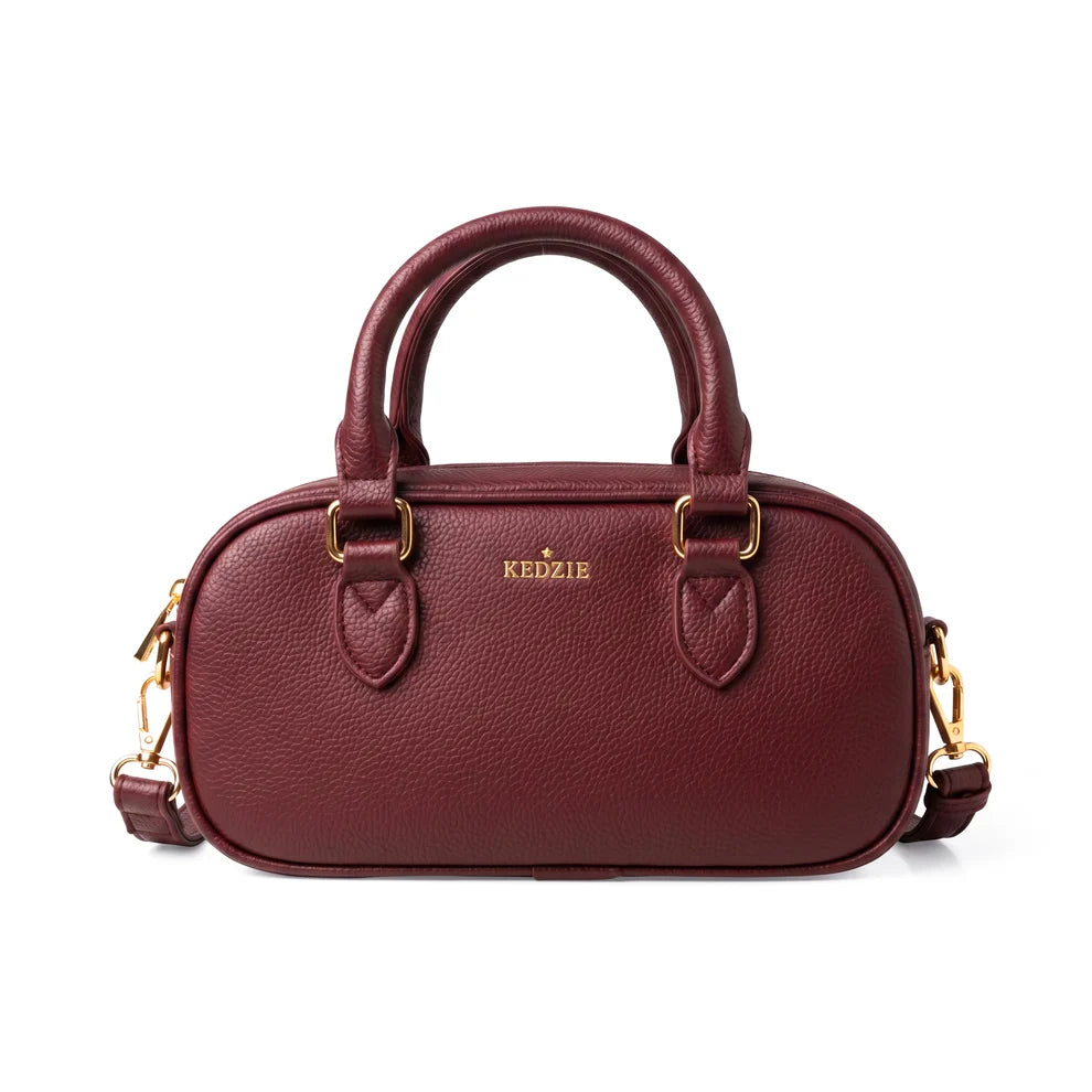 Burgundy crossbody bag from Kedzie with removable strap and tote handles on a white background