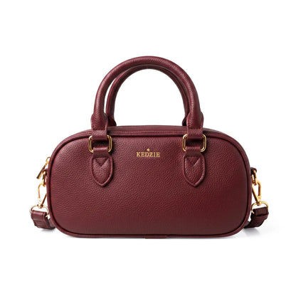 Burgundy crossbody bag from Kedzie with removable strap and tote handles on a white background