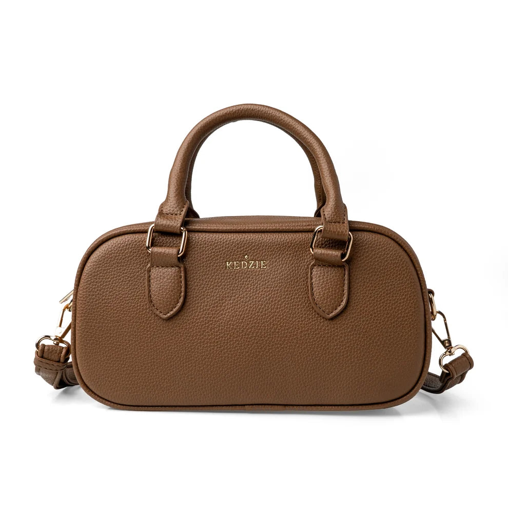Tan crossbody bag from Kedzie with removable strap and tote handles on a white background
