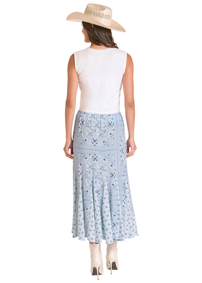 Woman wearing a white sleeveless top and light blue Panhandle Slim floral skirt with a beige hat on a white background