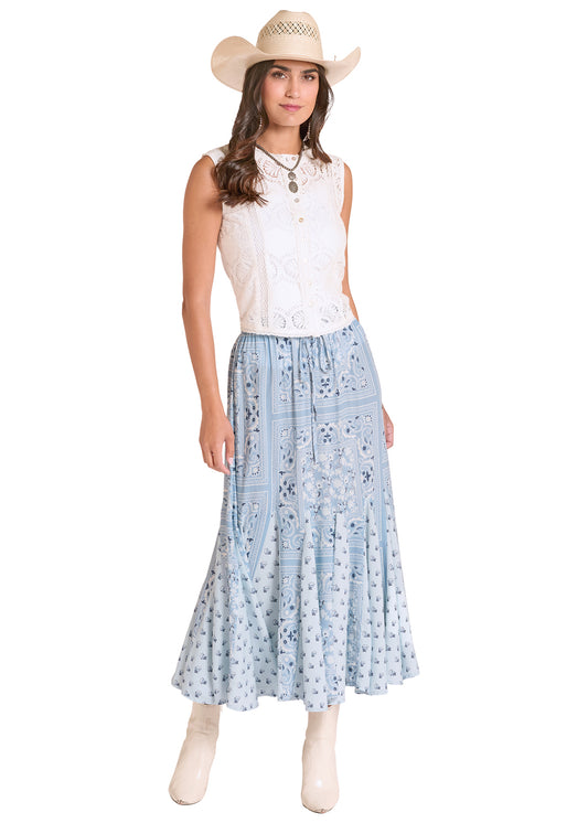 Woman wearing a white sleeveless top and a Panhandle Slim light blue floral skirt with a straw hat on a white background