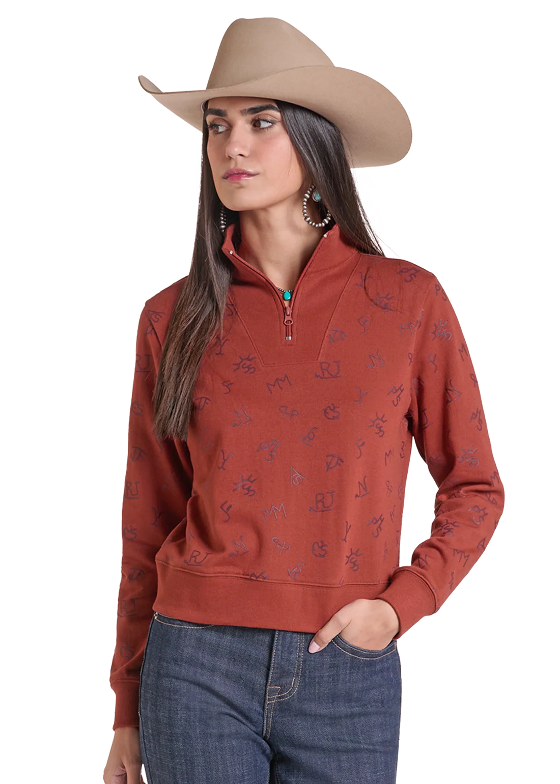 Woman wearing a pullover sweater by Panhandle Slim in rose color with blue jeans and a tan cowboy hat on a white background
