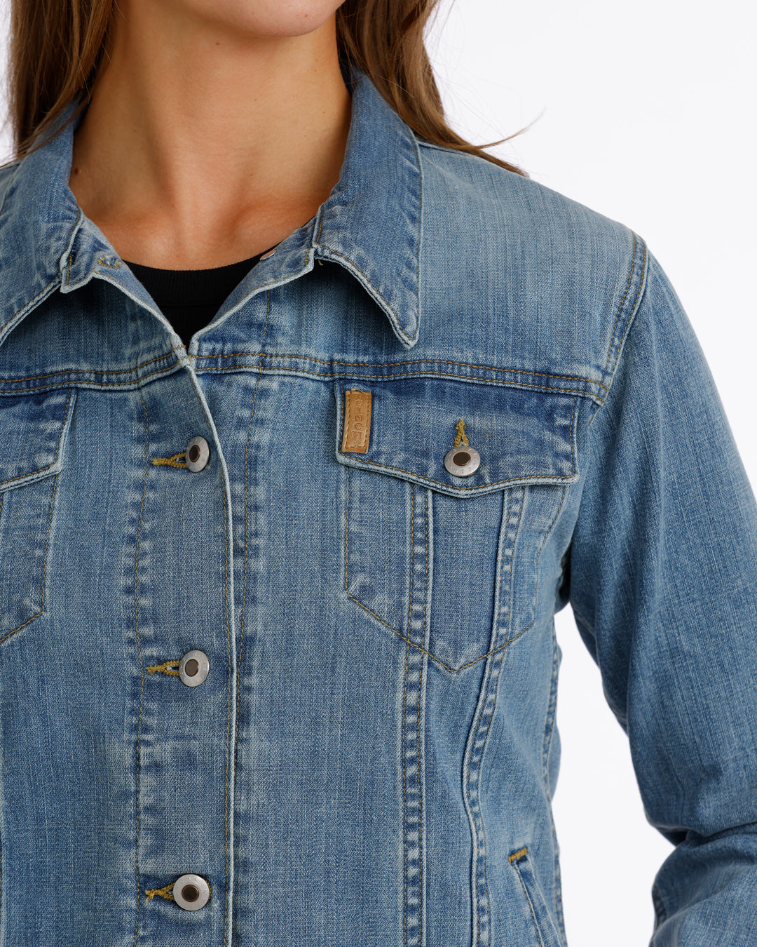 woman wearing a Cinch jean jacket on a grey background