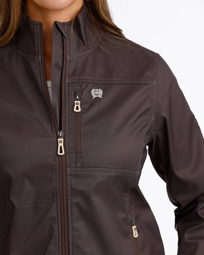 Woman wearing a brown Cinch jacket  on a white background