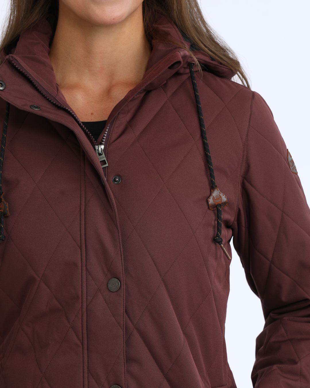 woman wearing a purple Cinch jacket  on a grey background