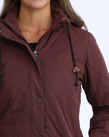 woman wearing a purple Cinch jacket  on a grey background