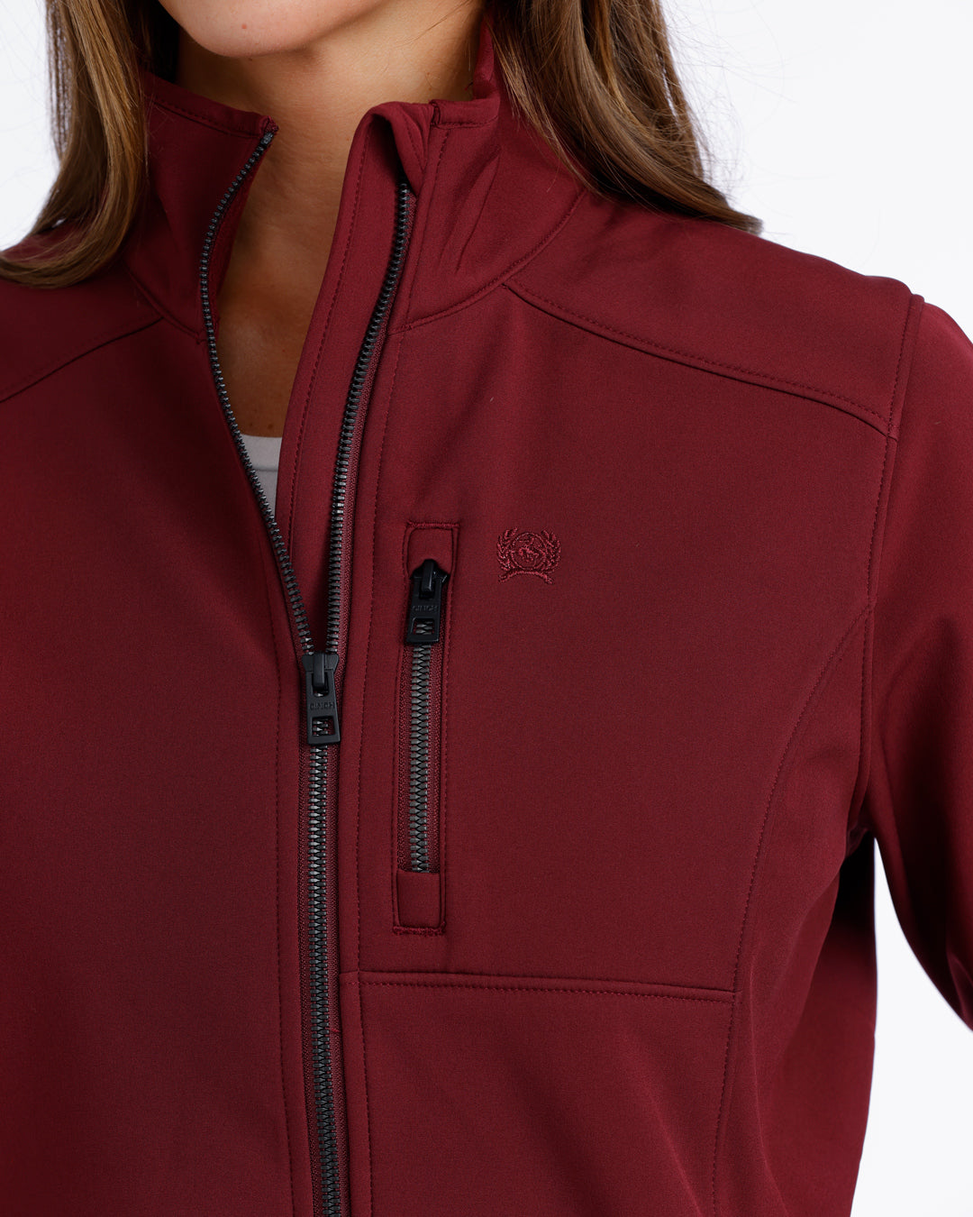 woman wearing a burgundy Cinch jacket on a white background