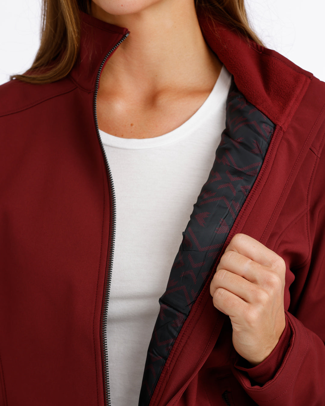 woman wearing a burgundy Cinch jacket with a black inside and a white t shirt on a white background