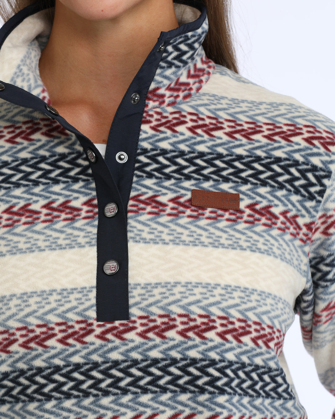 woman wearing a multi colored fleece Cinch sweater on a white background