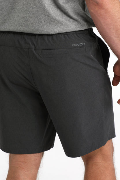 man wearing Cinch Athletic shorts on a white background
