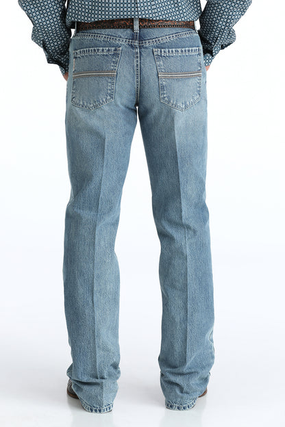 Relaxed light blue Cinch jeans worn by a person on a white background