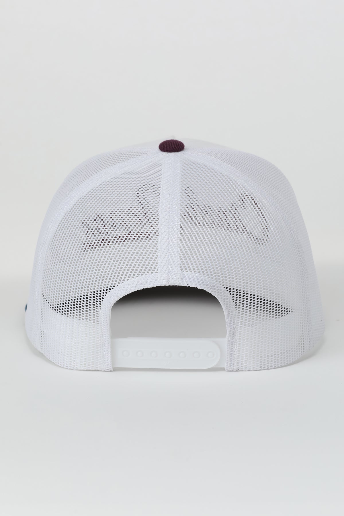 White mesh Cinch cap with a red button on a light gray background