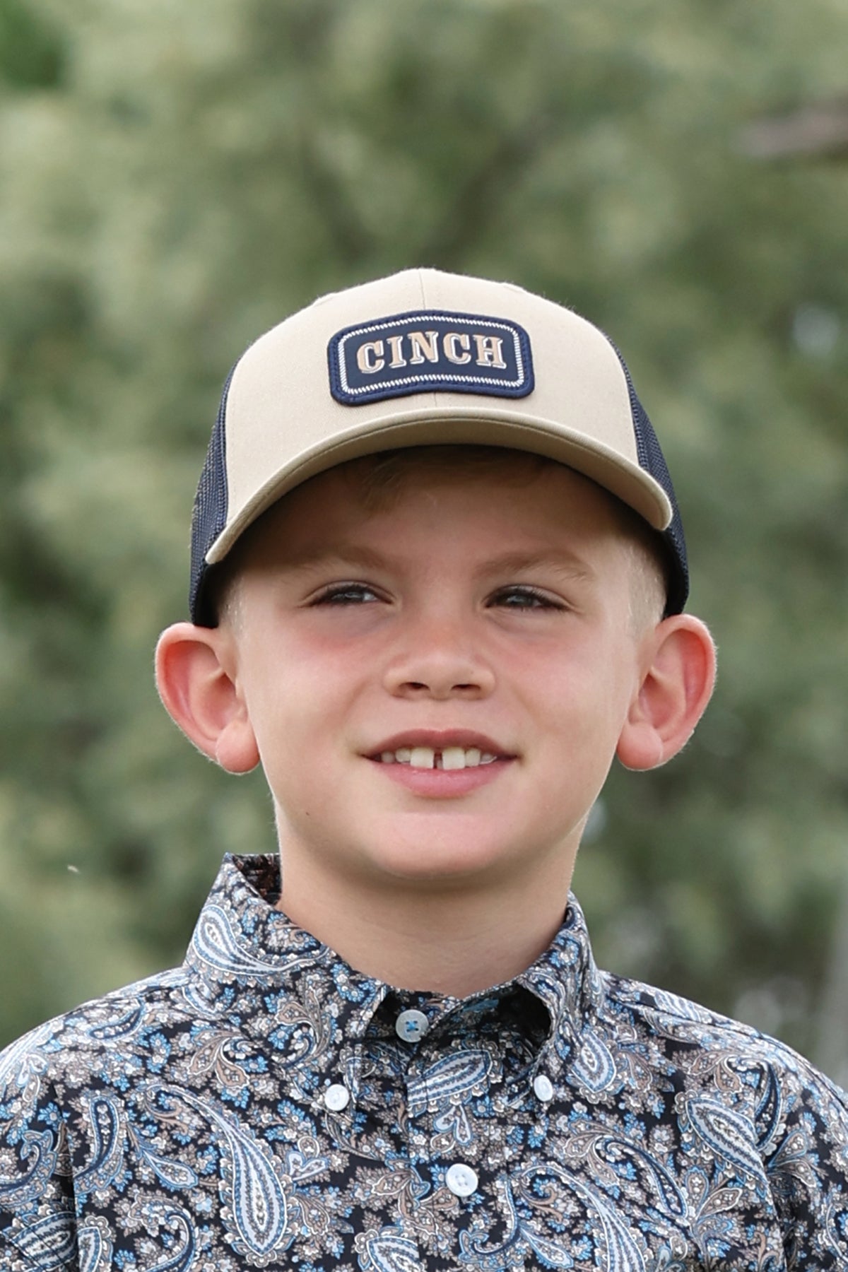 Boy wearing a brown Cinch ball cap
