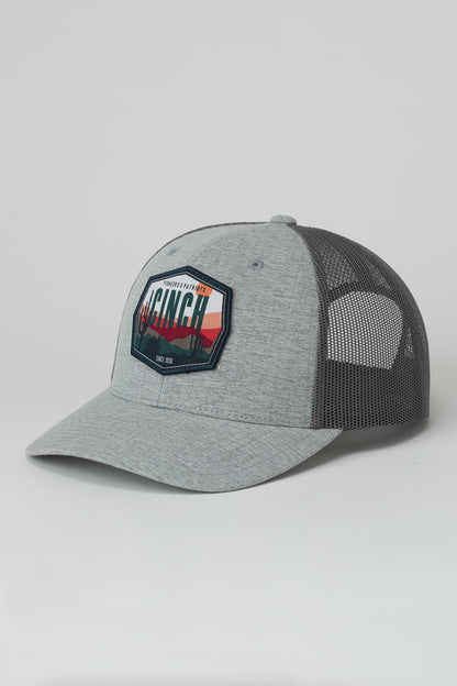 Gray and black mesh cap with a Cinch logo on a light gray background