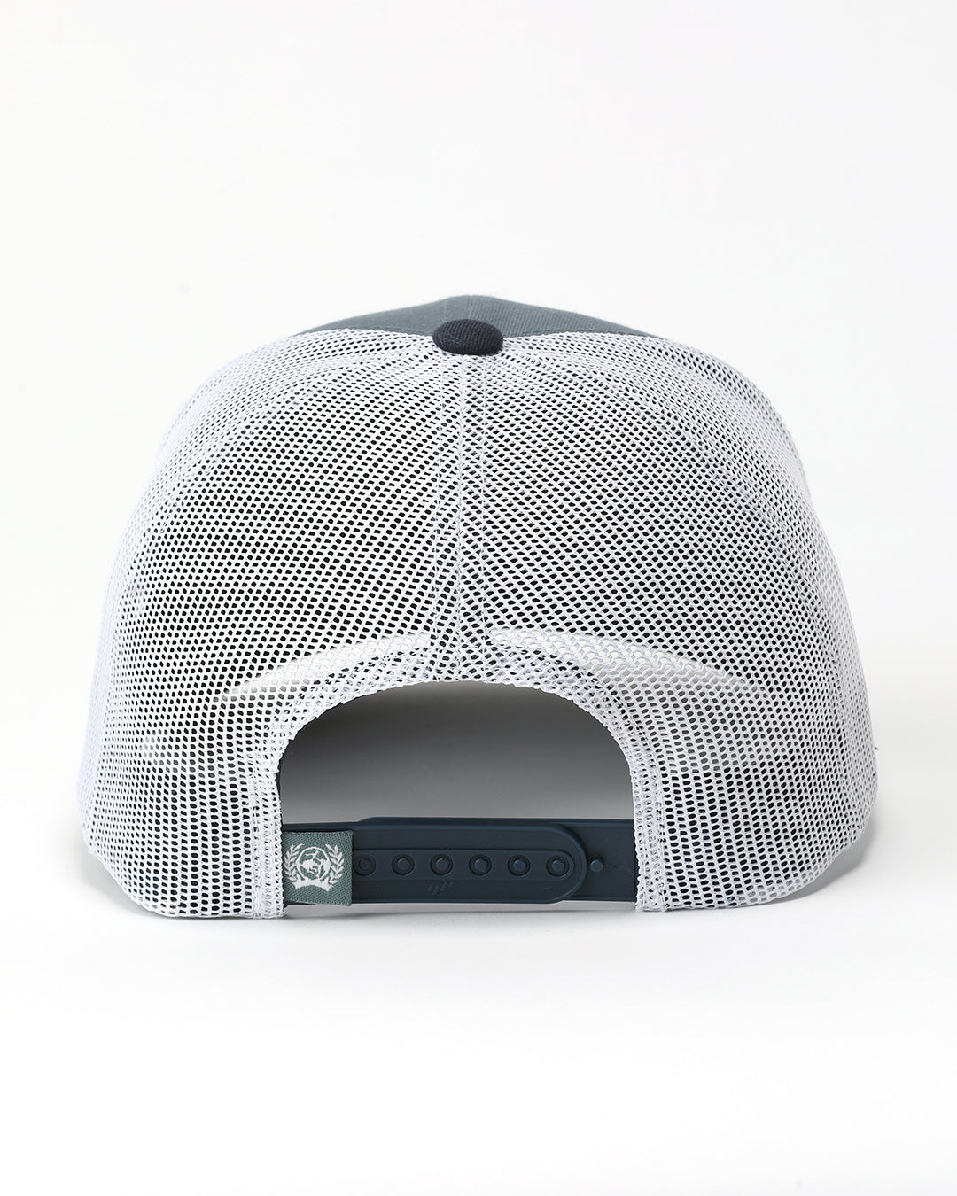 The back view of a Cinch hat featuring a white mesh back, a dark gray fabric crown, and a black adjustable snap closure.