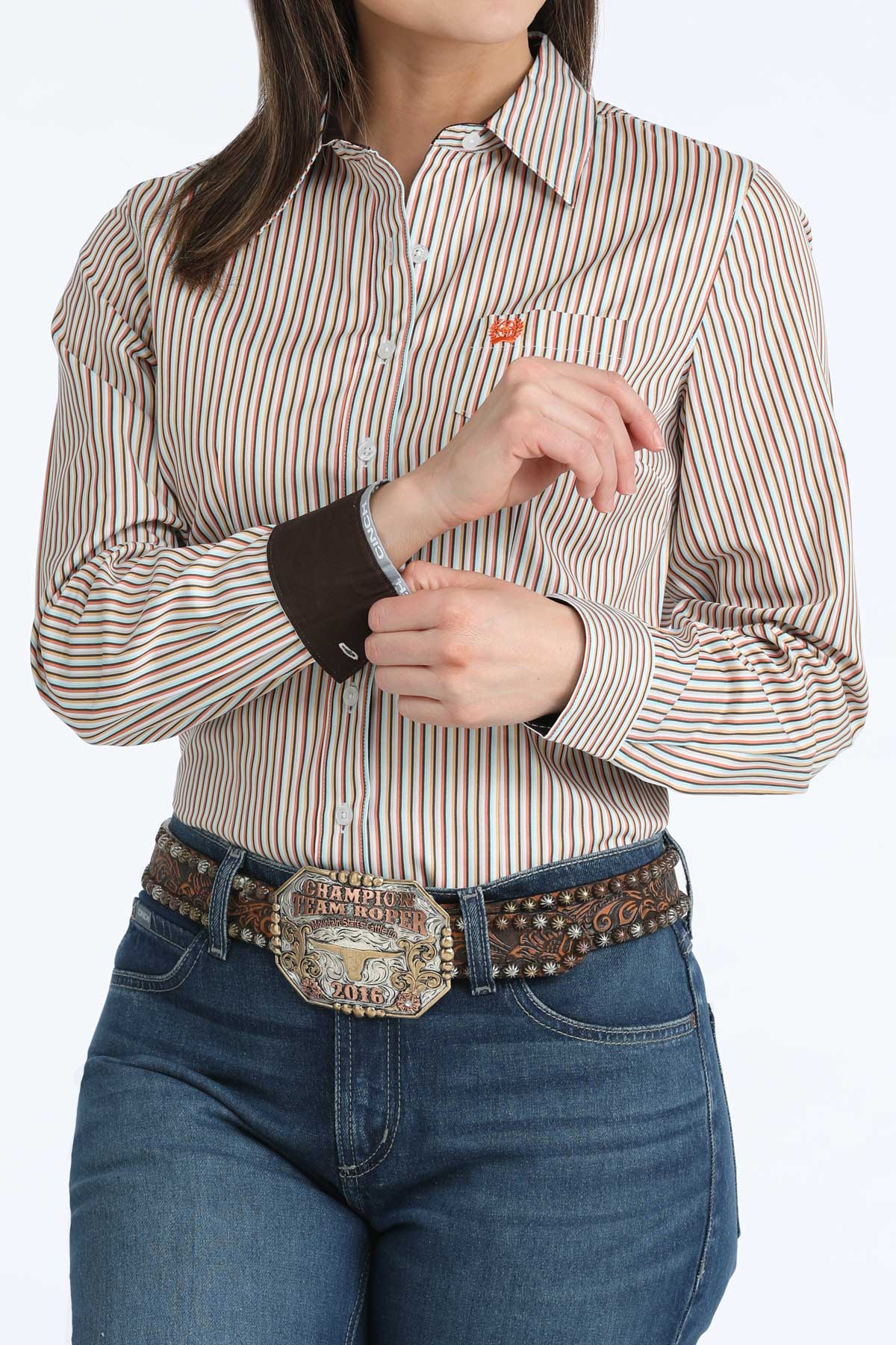 Person wearing a striped 'Cinch' shirt and jeans with a decorative belt on a white background