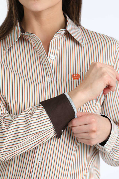Person wearing a striped 'Cinch' shirt with a brown cuff, adjusting it.